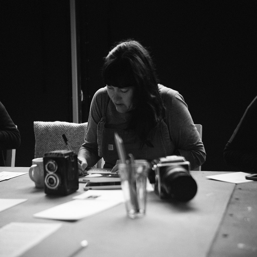 Woman drawing at table