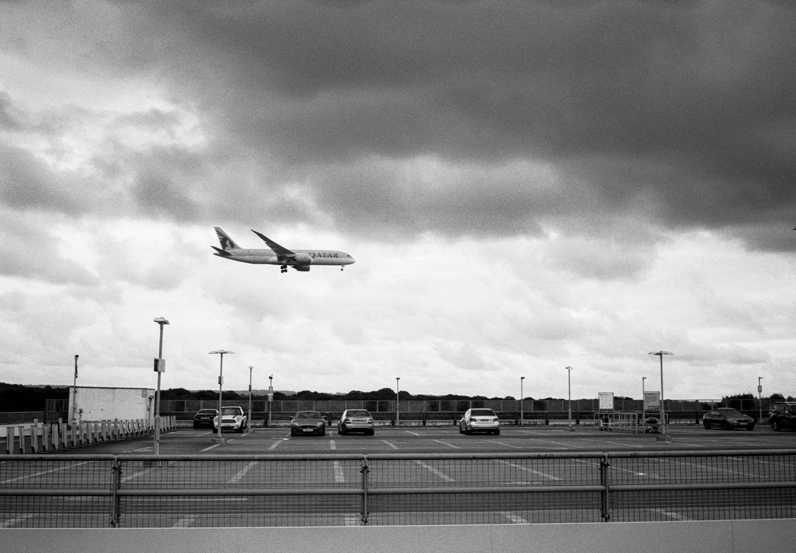 Plane flying over carpark