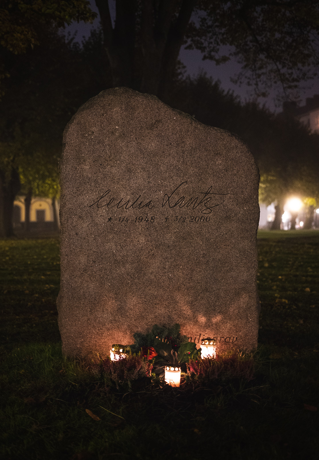 Candles in front of gravestone