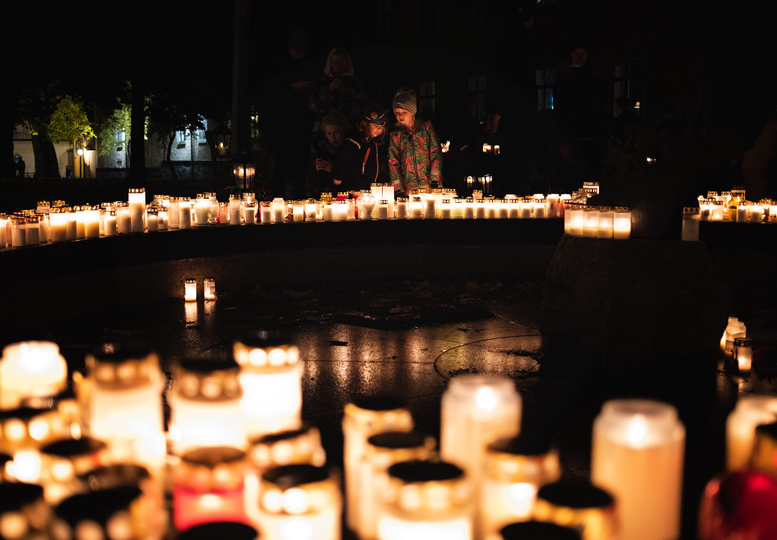 People looking at candles