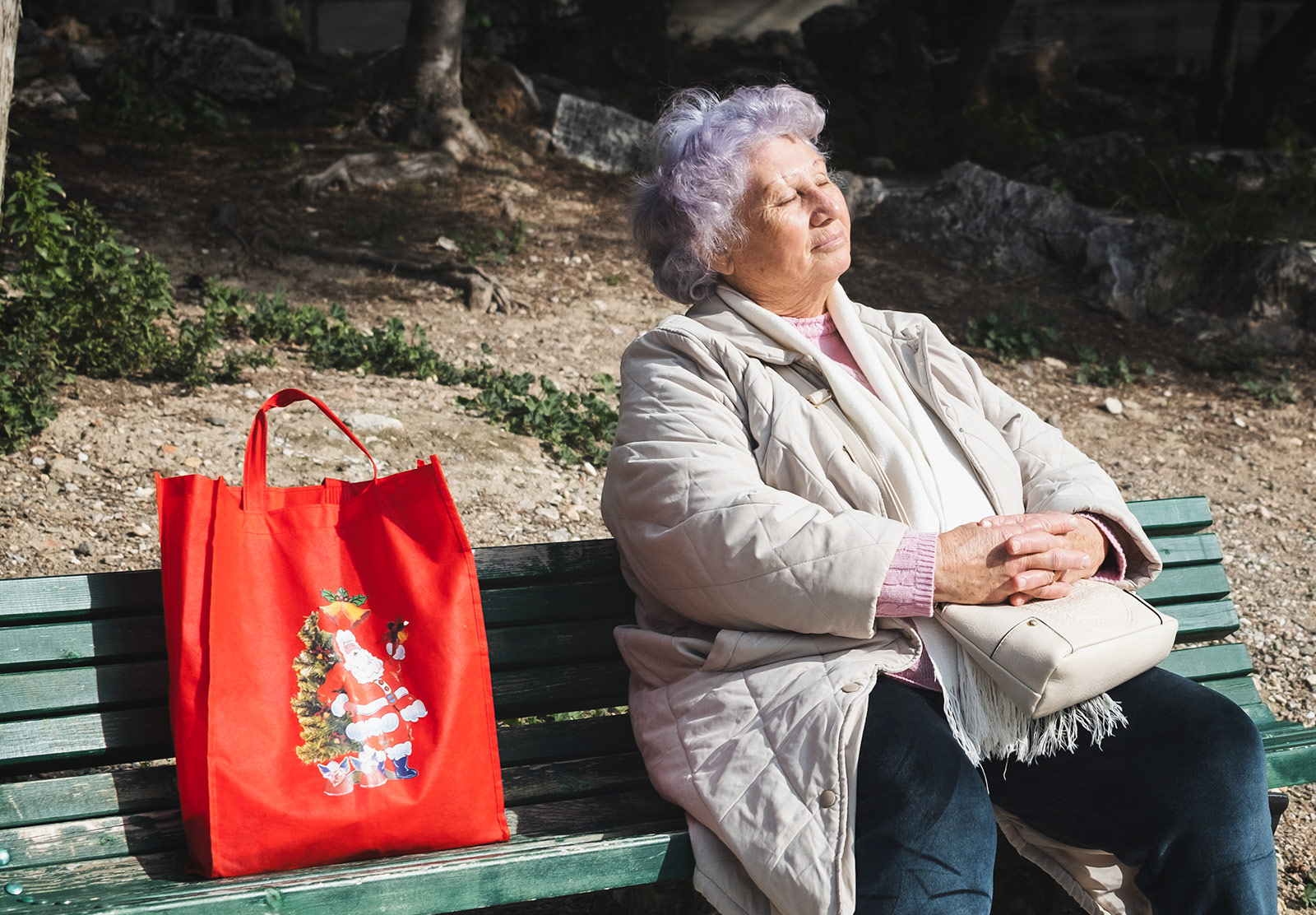 Lady sat on bench in the sun
