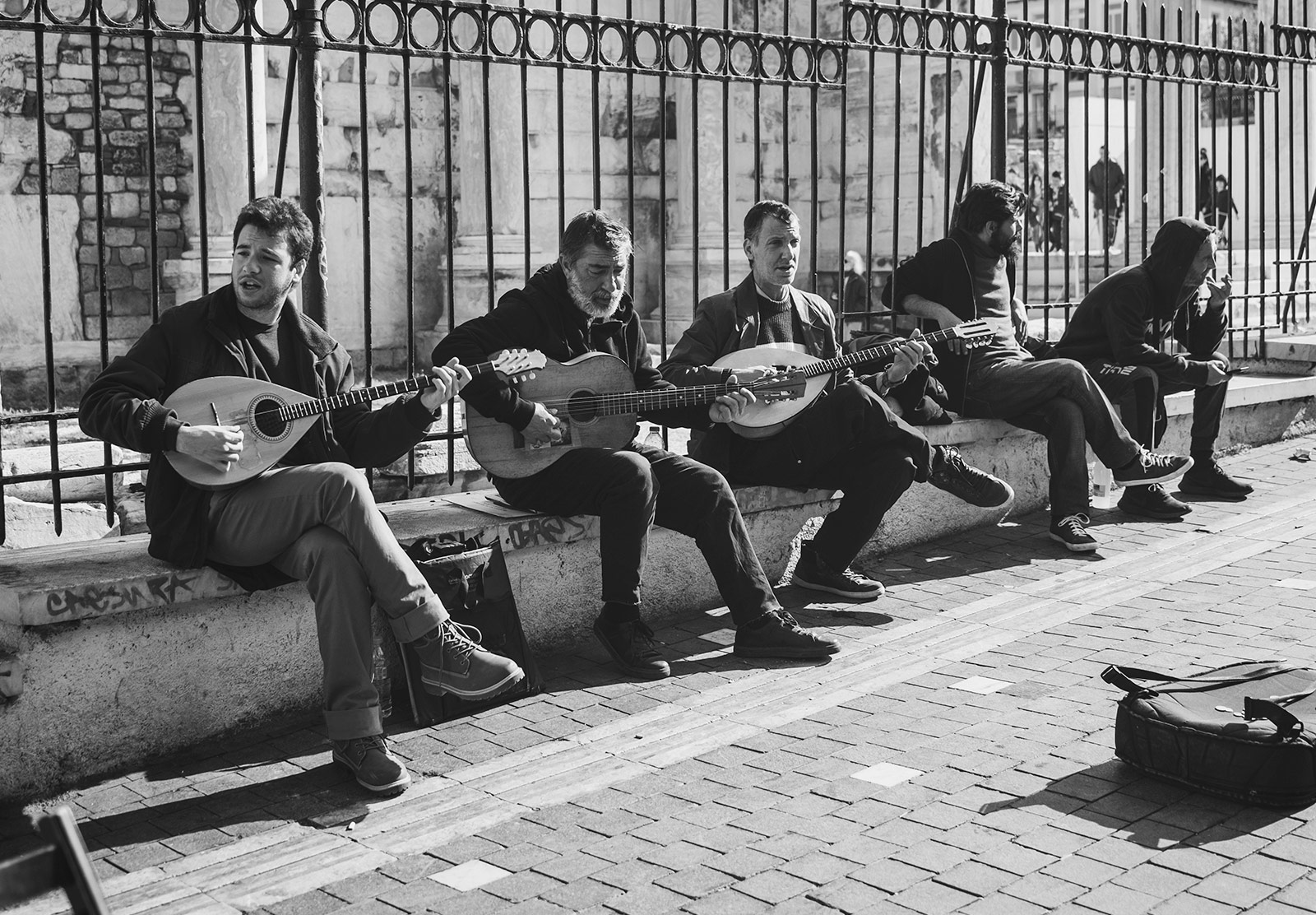 Musicians sitting on a wall