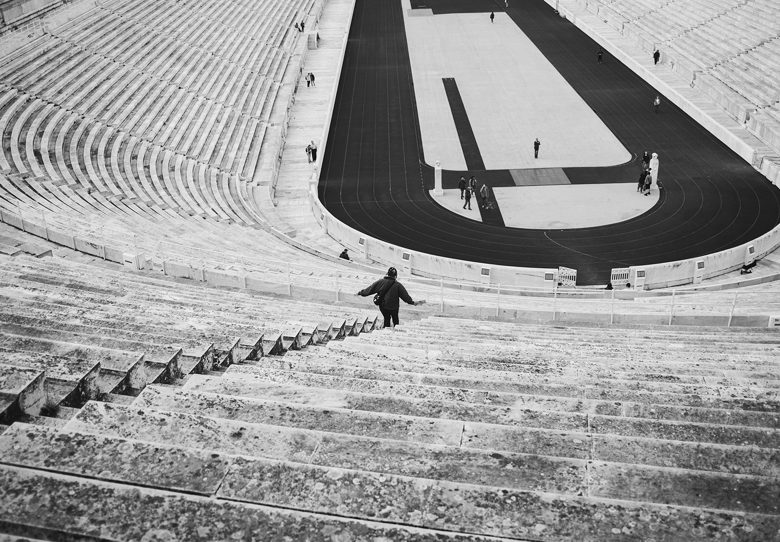 Woman walking down steep stone steps