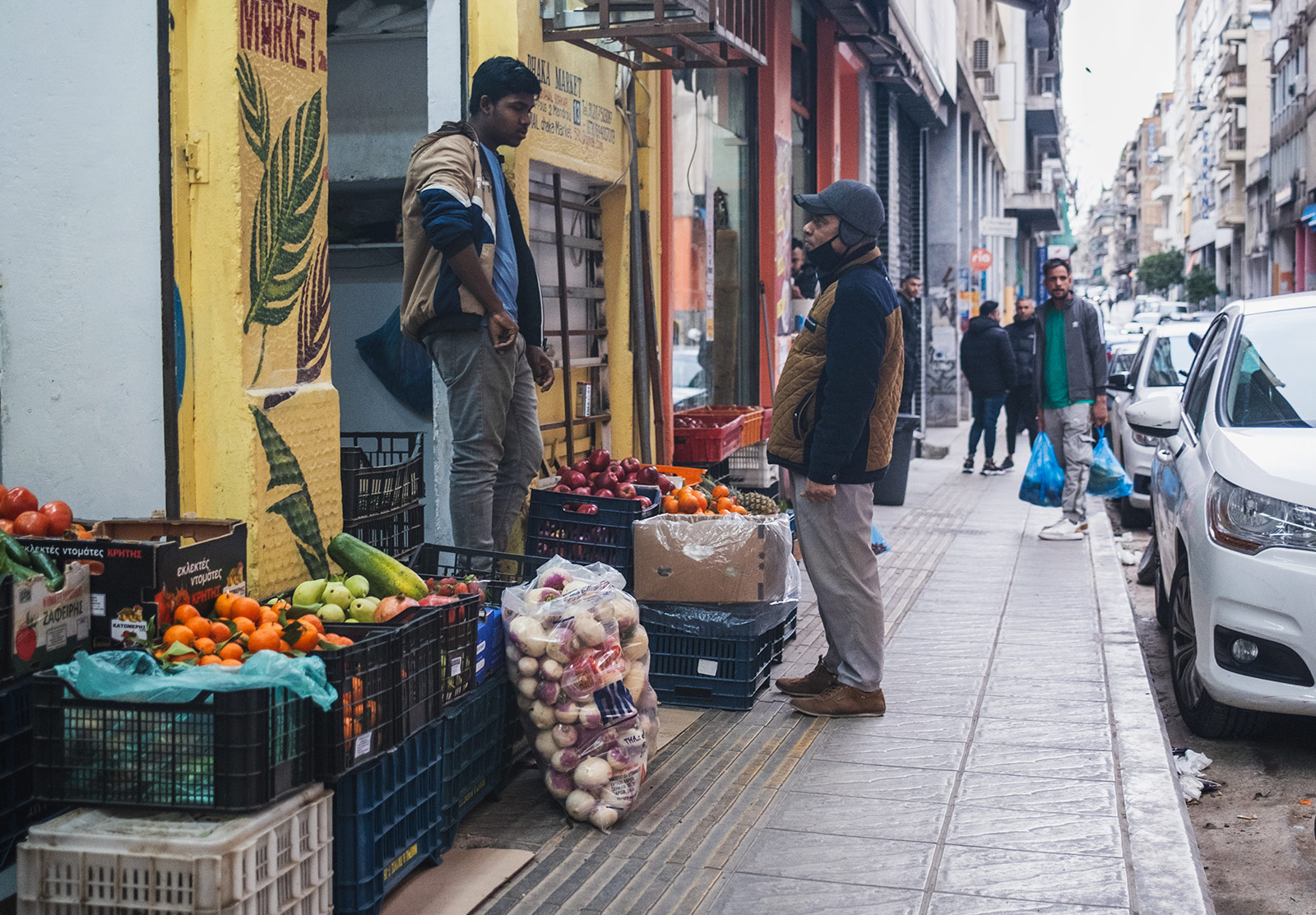 Shop owner talking to customer on the street