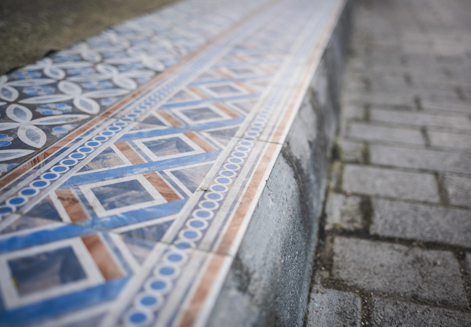 Decorative tiles on kerb
