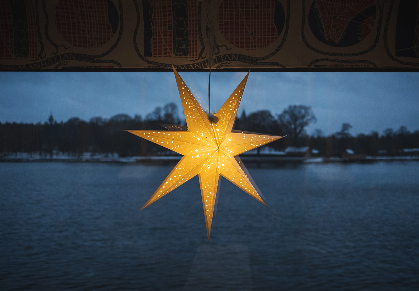 Glowing paper star hanging in window