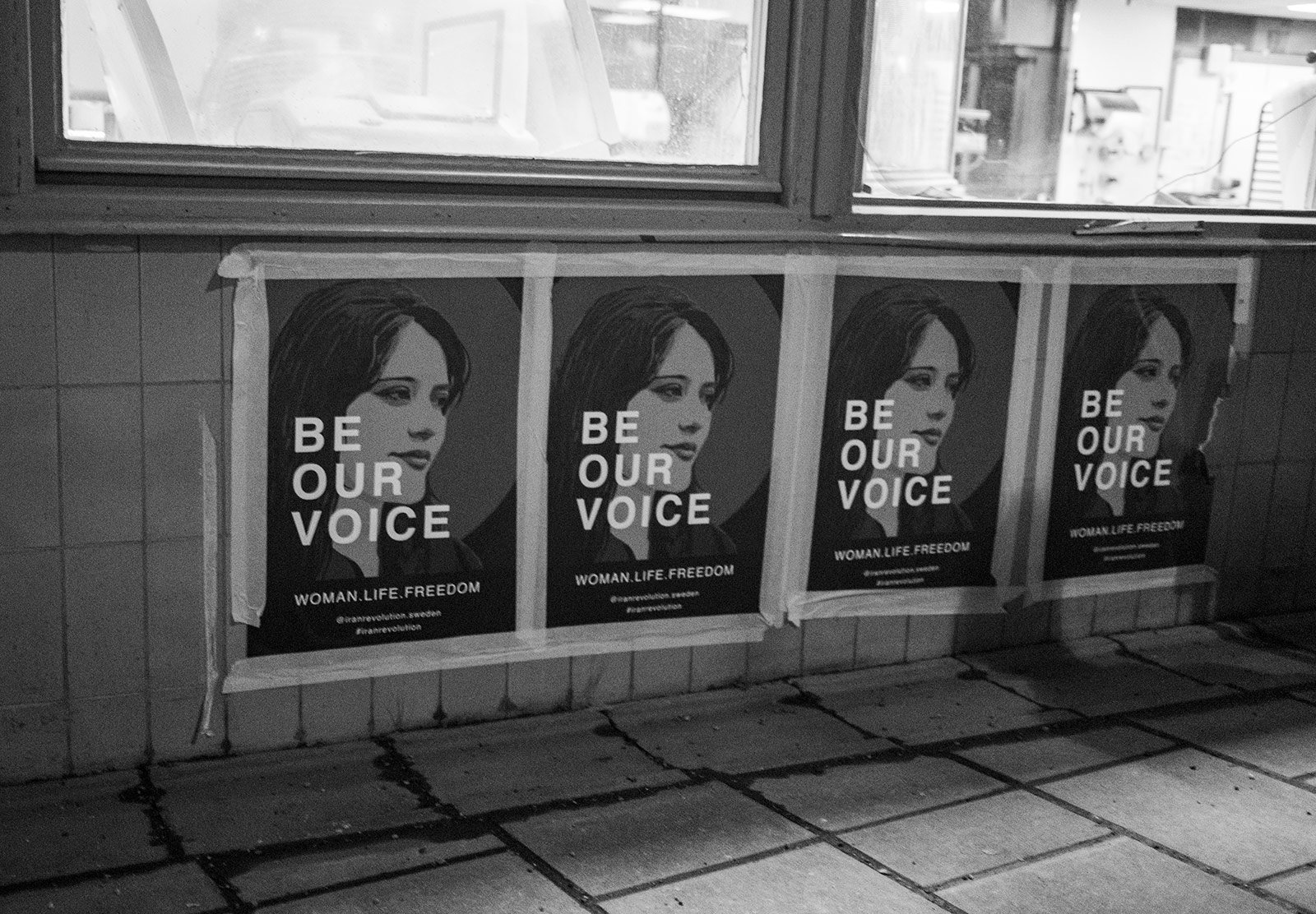 Posters taped to a wall
