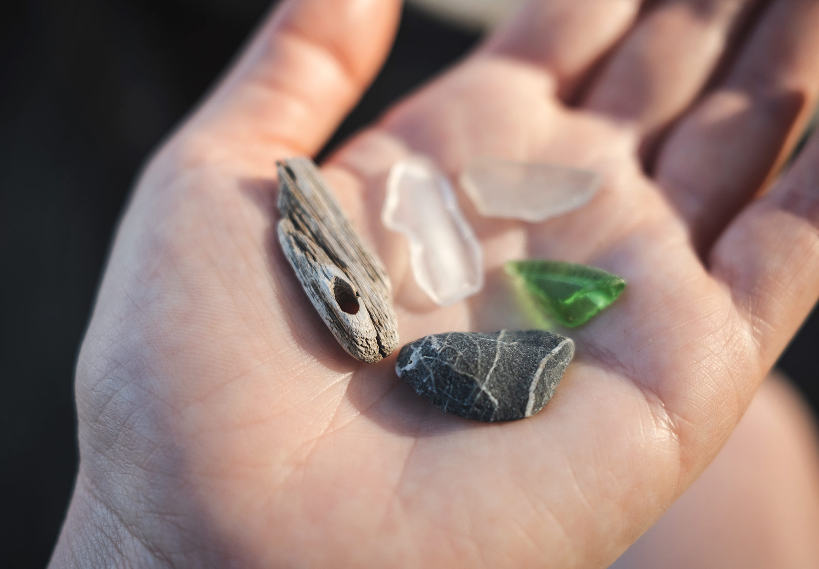 Glass, pebble and wood in hand