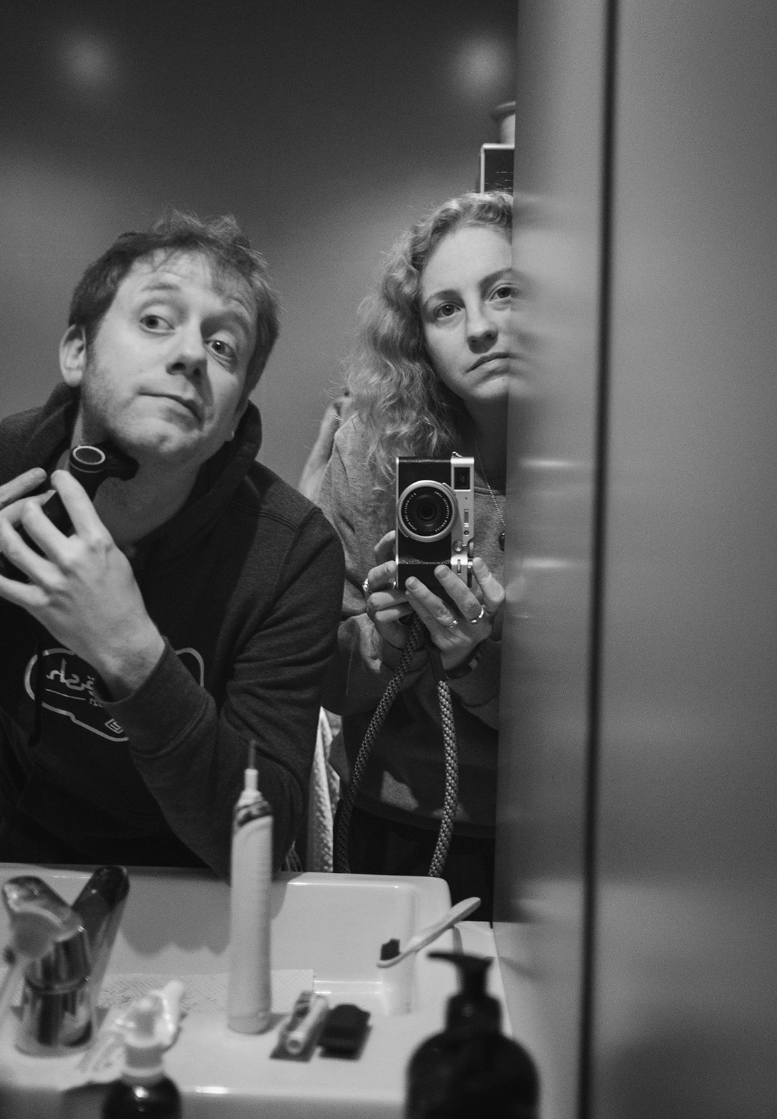 Woman watching man shave
