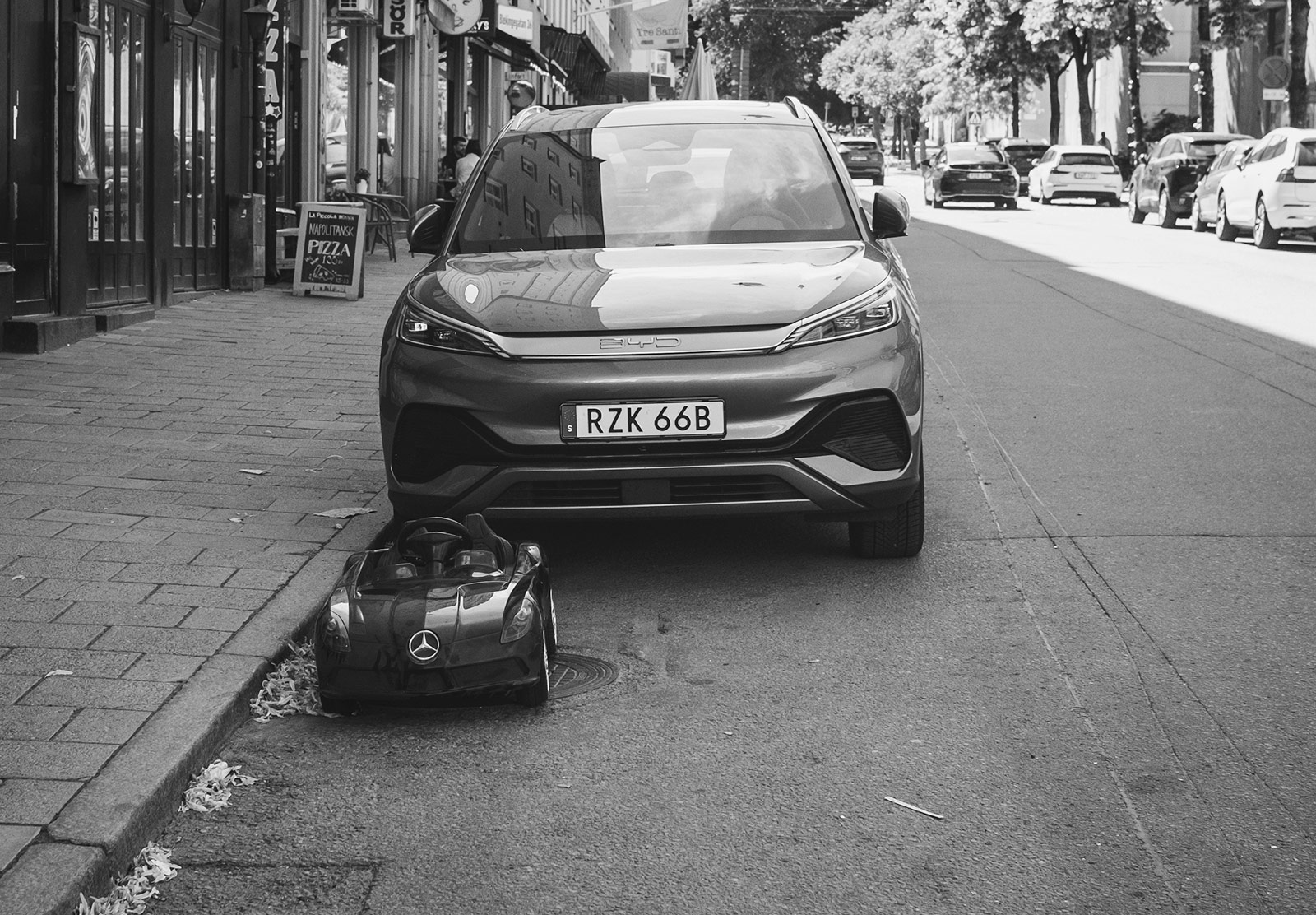 Car with toy car in front