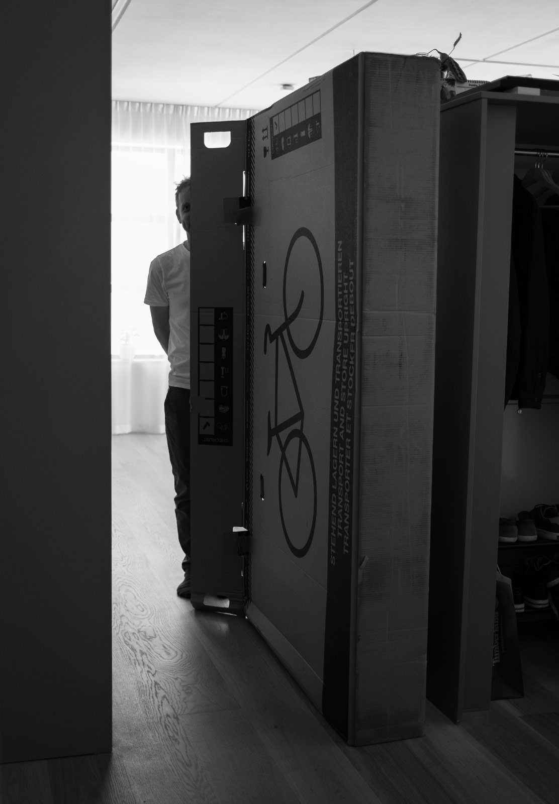 Man standing next to tall box