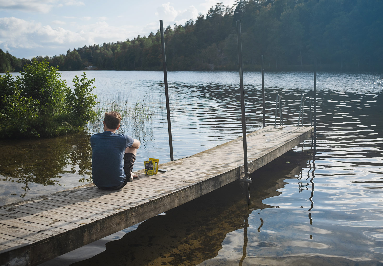 Man sitting on wooden jetty