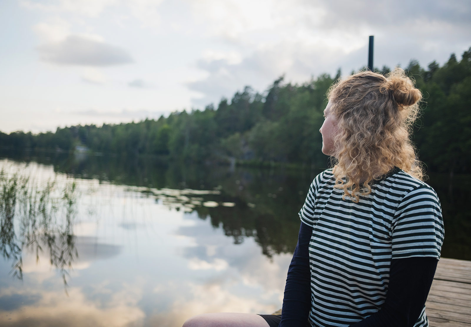 Woman looking out over lake
