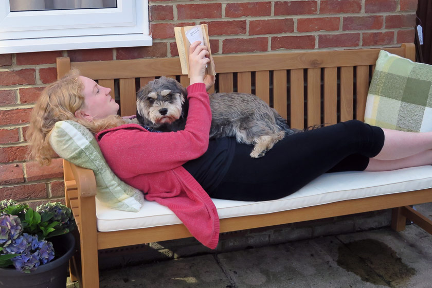 Laying on bench with dog