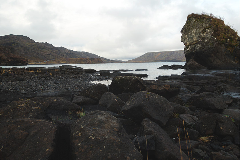 Black rocks at lake edge