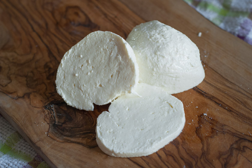 Mozzarella slices on wood board
