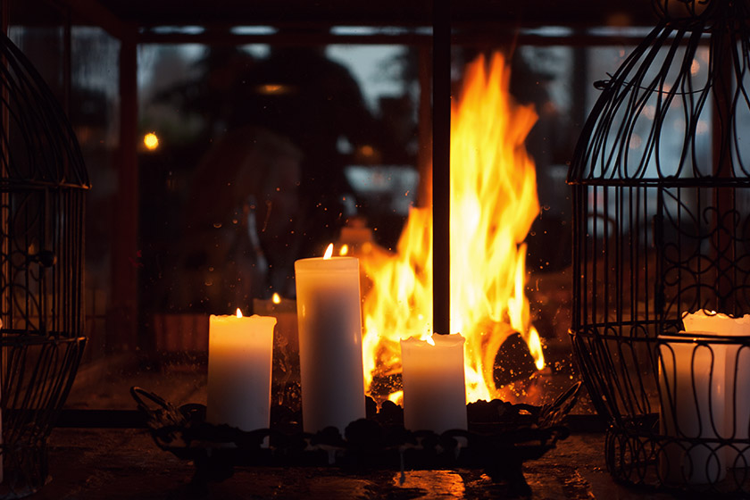 Glowing candles by a fire