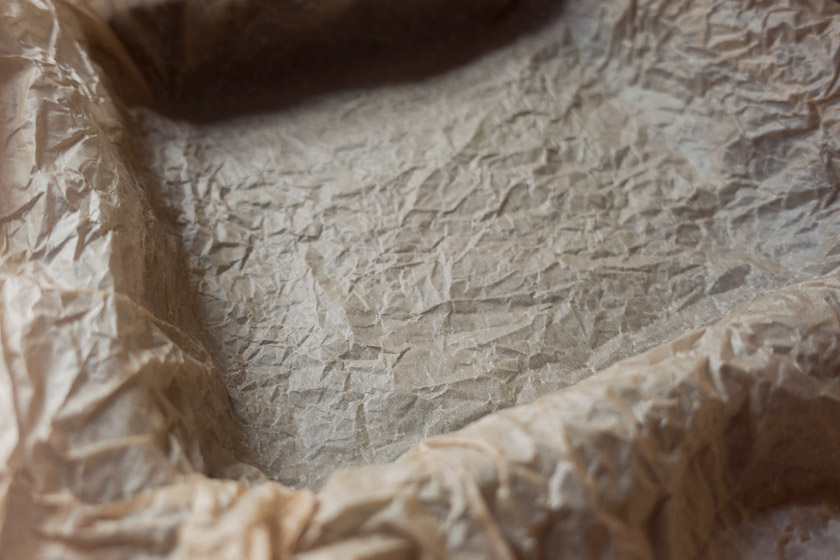 Crumpled parchment in tin