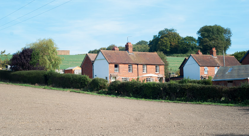 Cottages next to empty fields