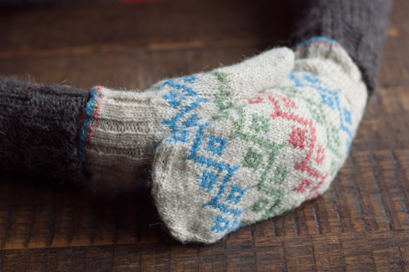 Clasped hands in mittens