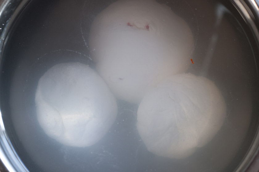 Mozzarella balls in bowl of water
