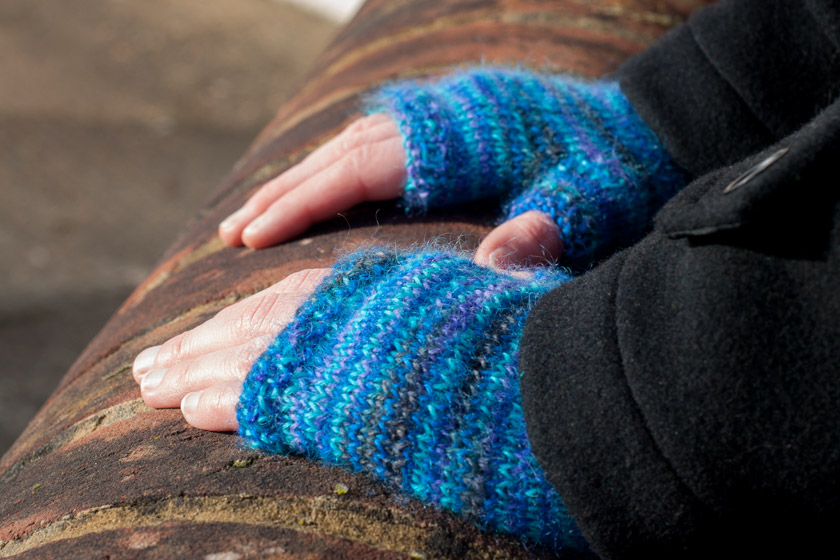 Hands in blue gloves on wall