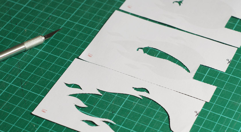 Cut out paper stencils in a row