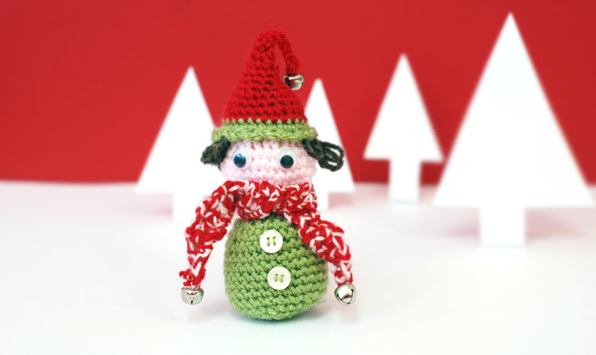 Crochet elf wearing a hat with bells on