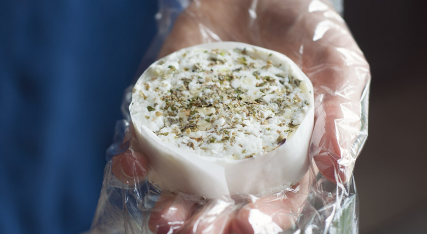 Homemade goats cheese topped with garlic and herbs