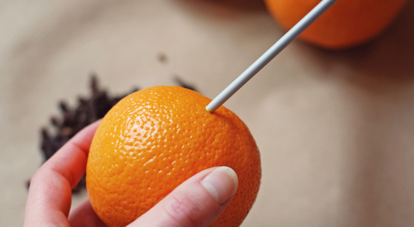 Making holes in the pomander with a knitting needle