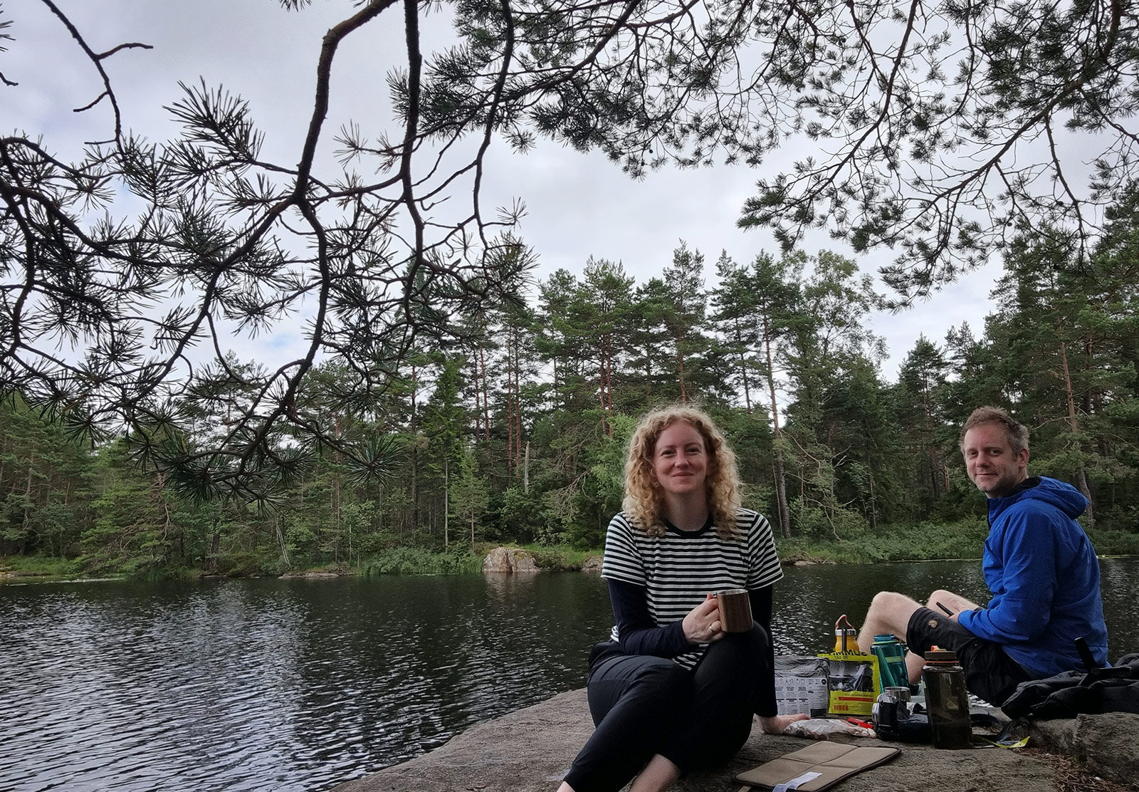 Couple sat by lake