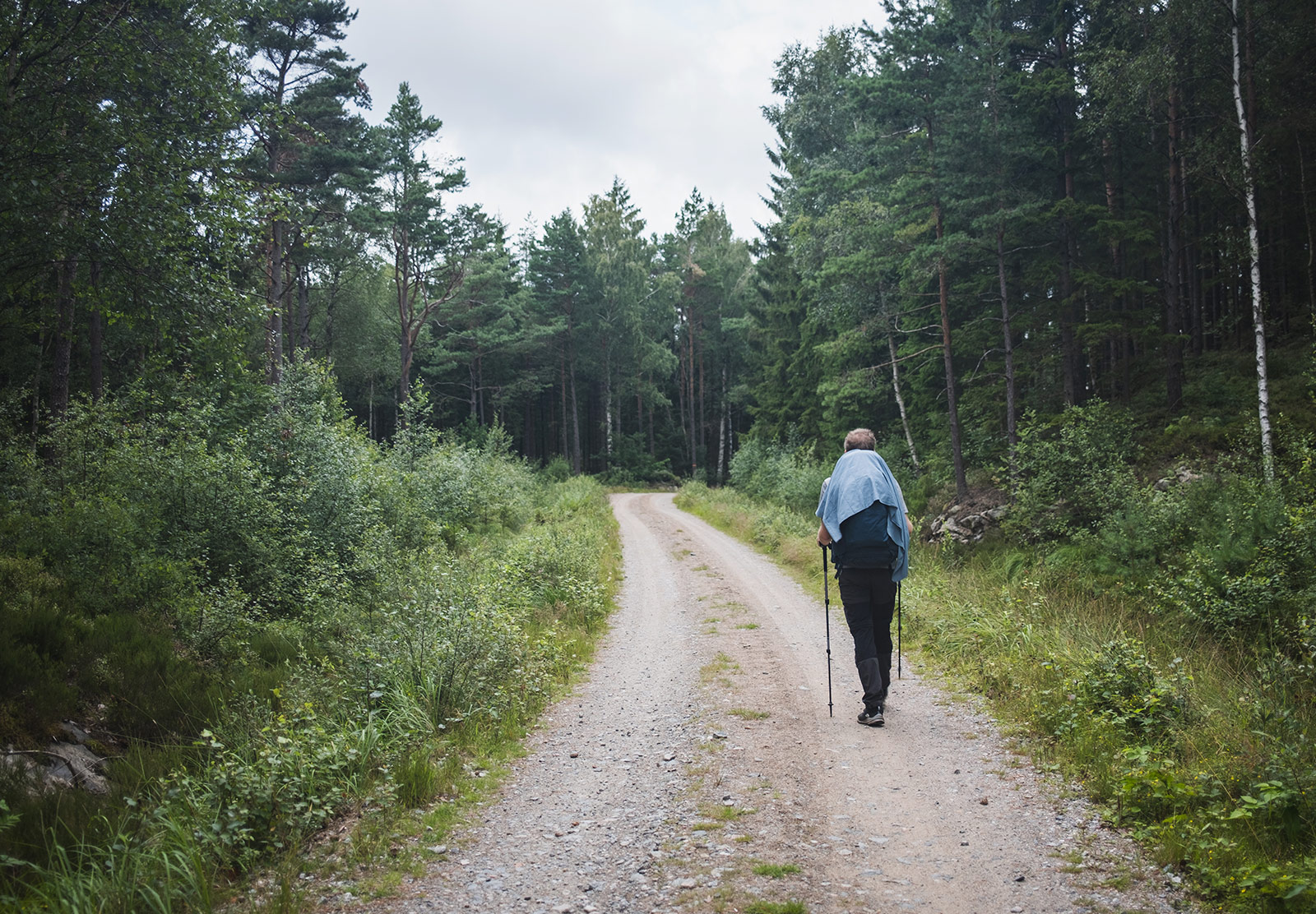Man walking along road with bag