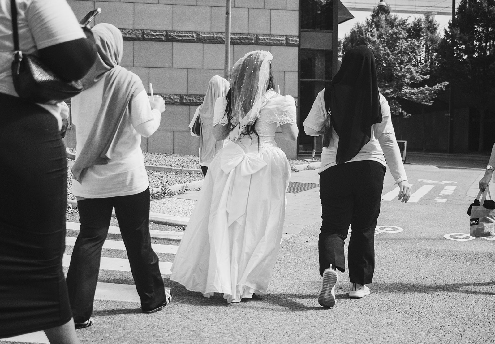Woman in wedding dress with friends