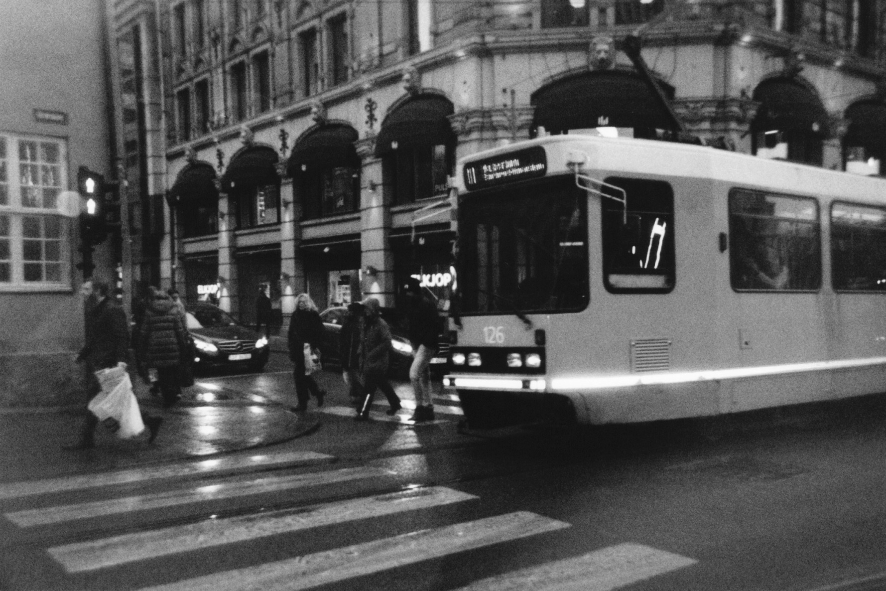 People walking past tram