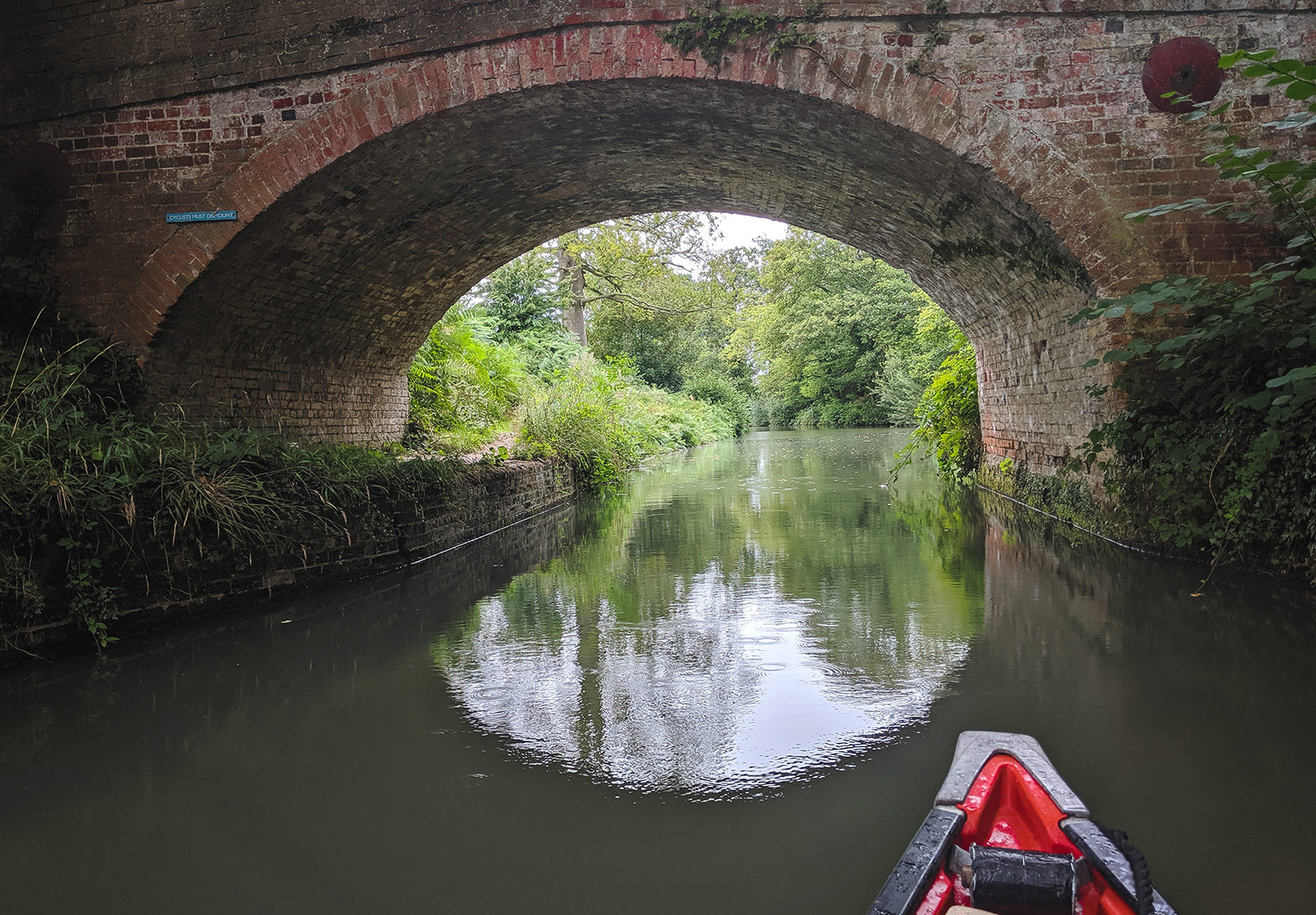 Water under red brick bridge