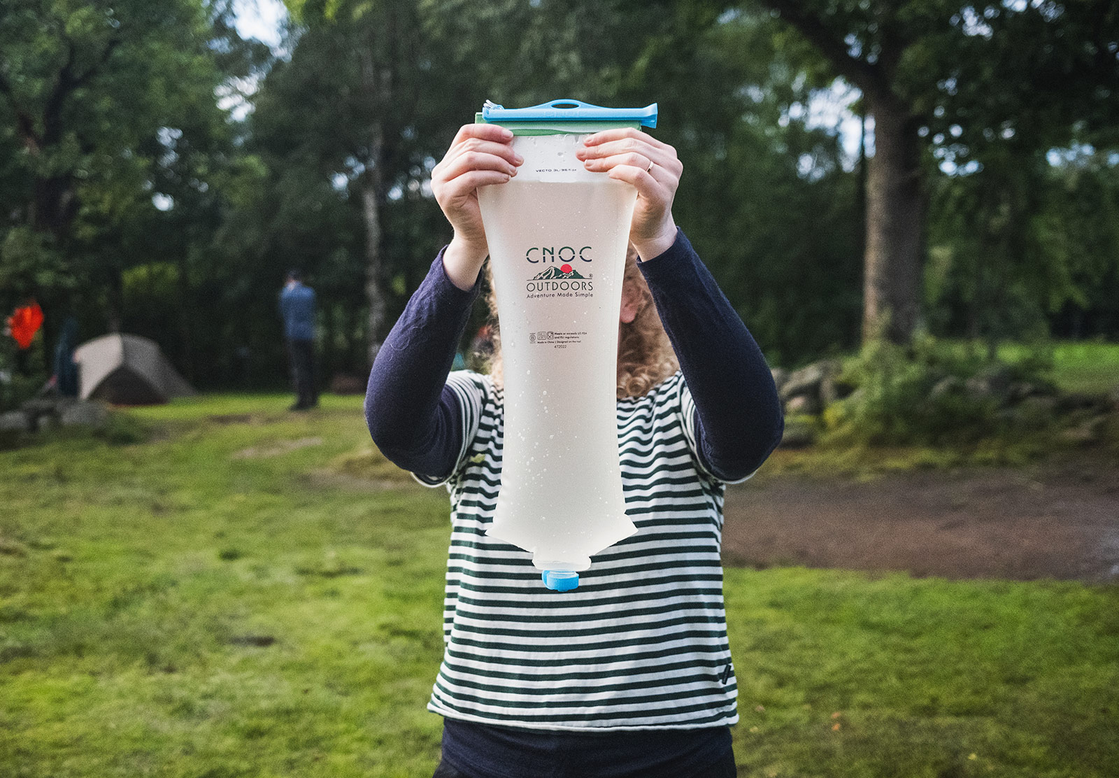 Woman holding large bag of water