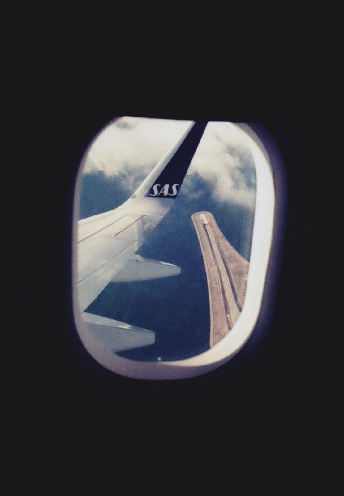 Plane wing and clouds