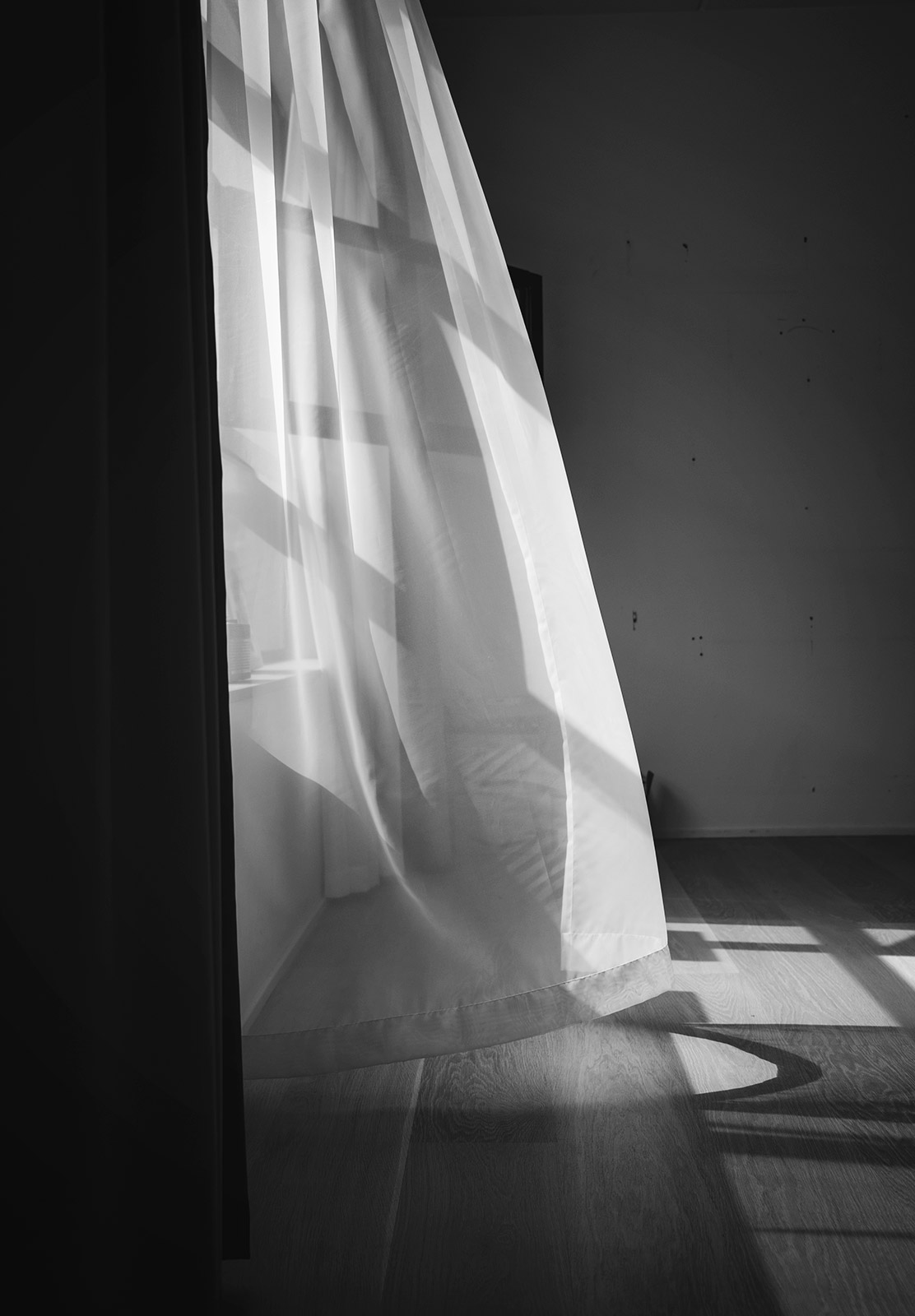 Net curtains blowing in the breeze