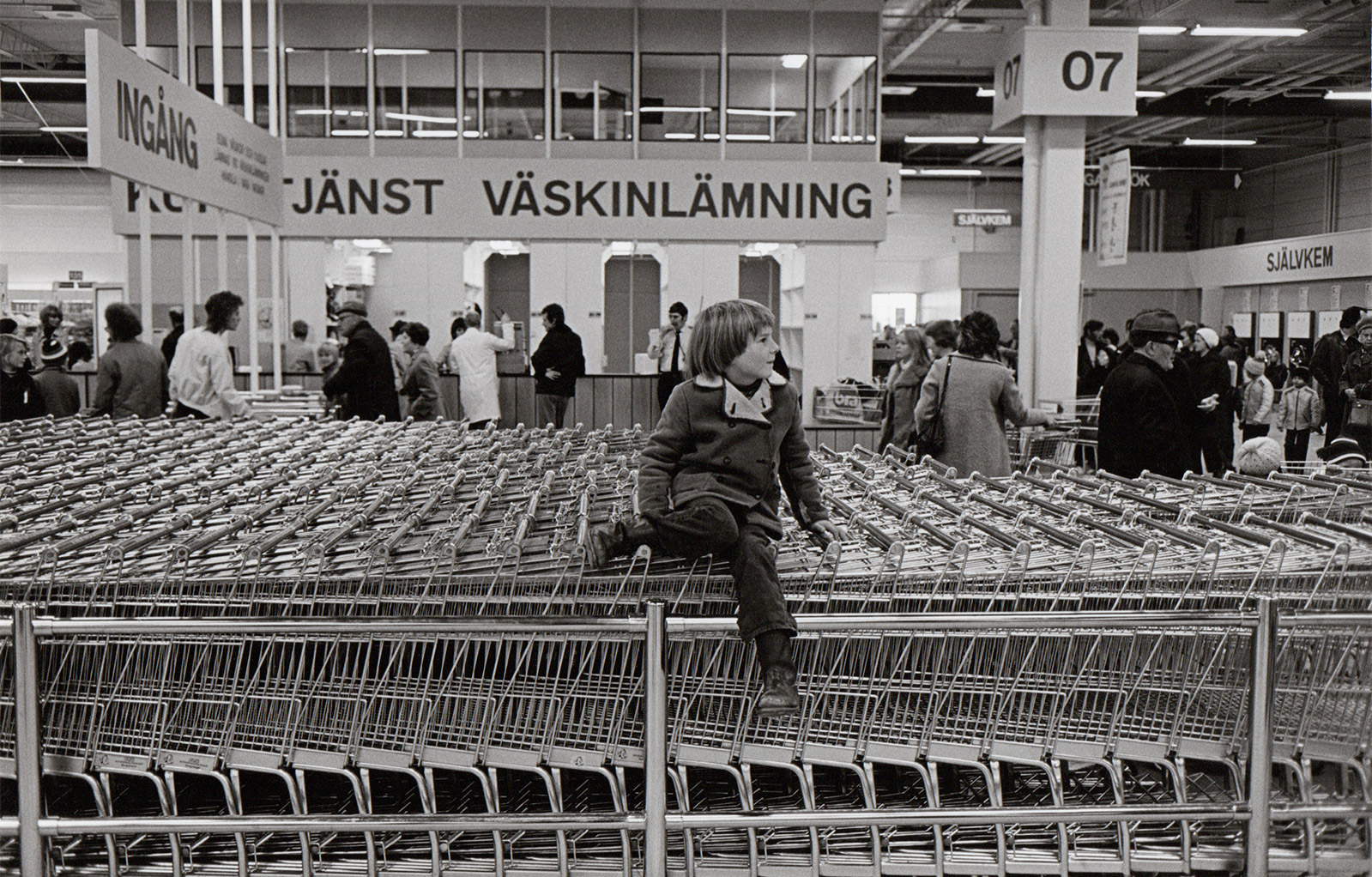 Young boy sat on trolleys