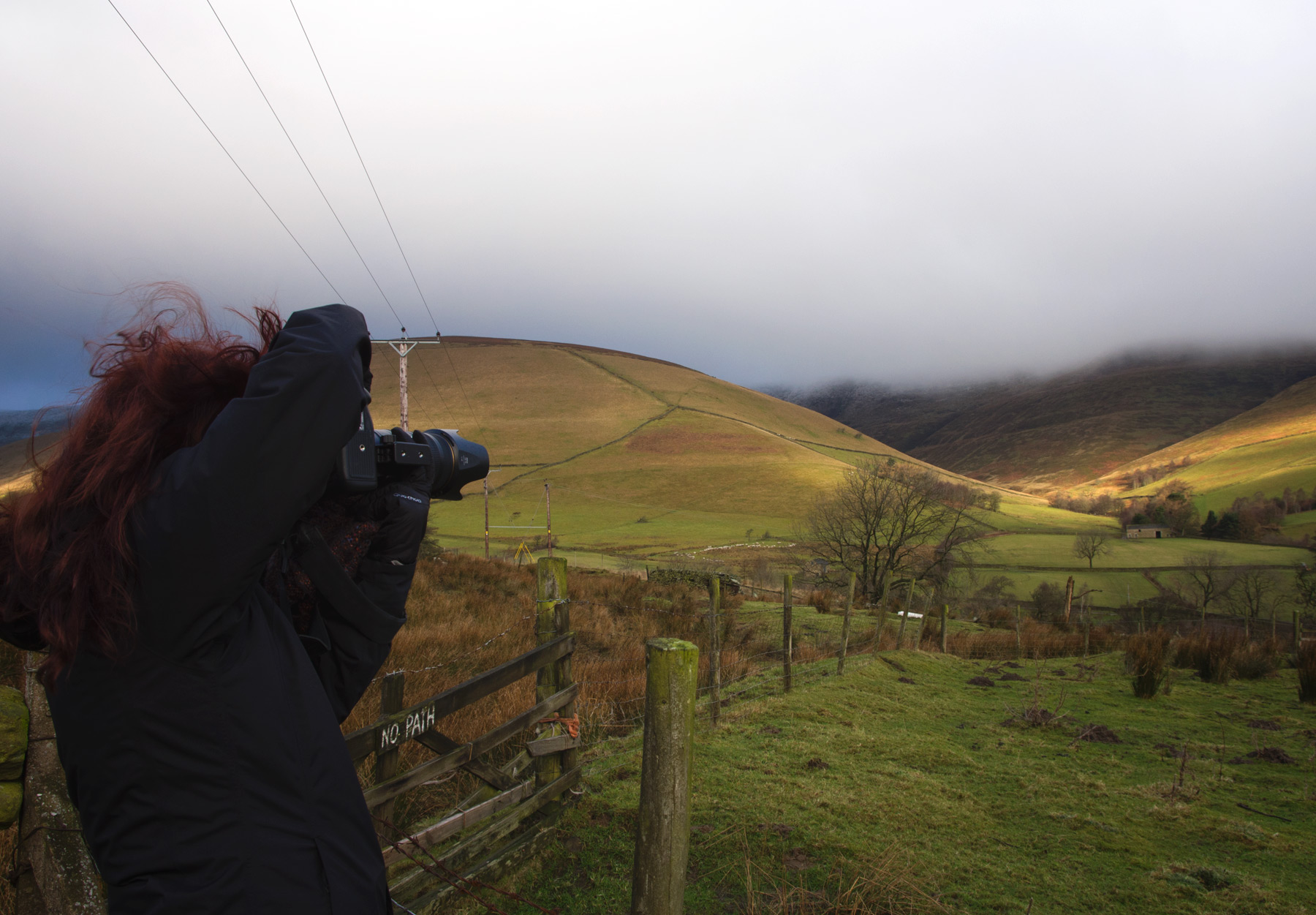 Woman photographing hills