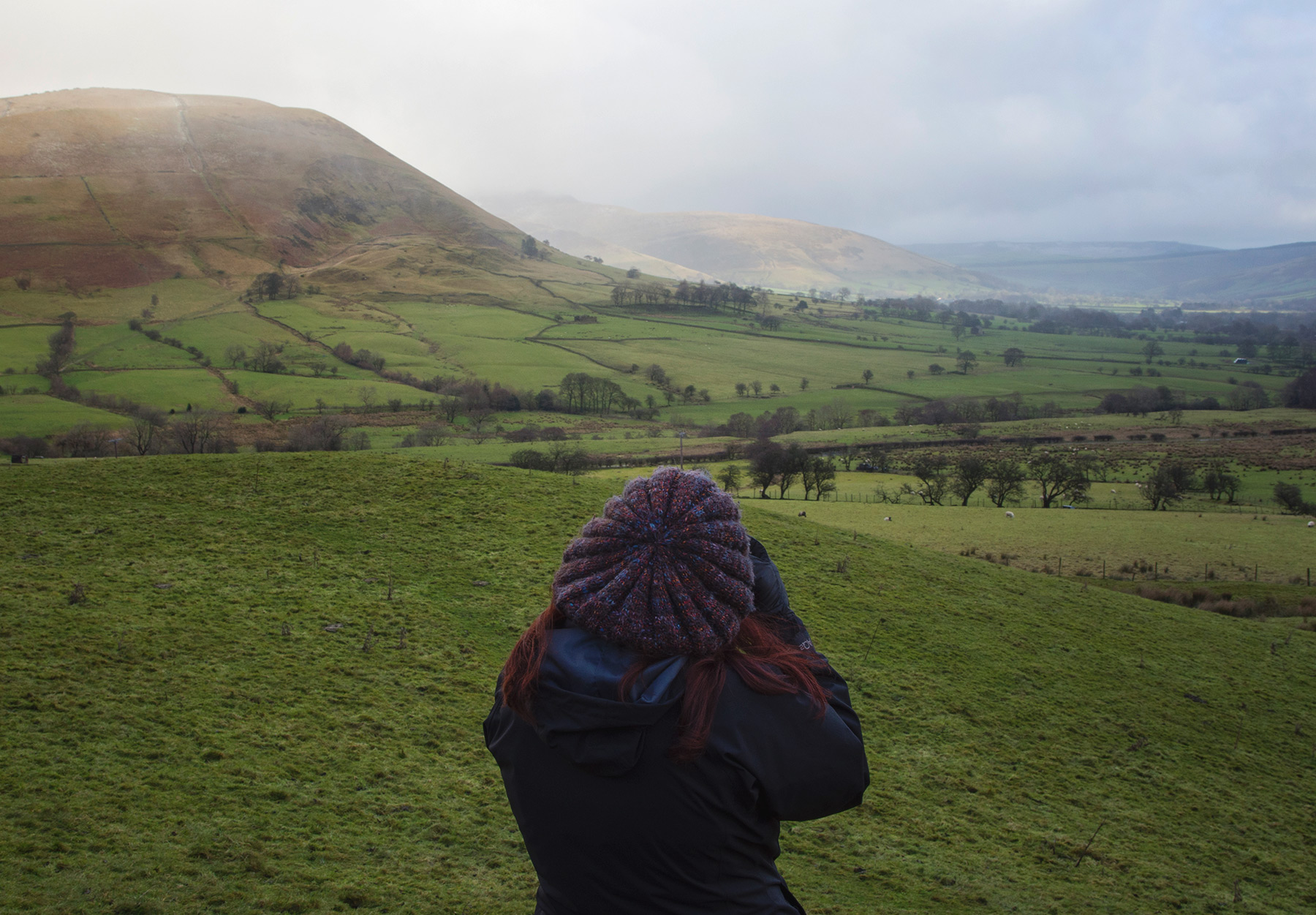 Figure against green landscape