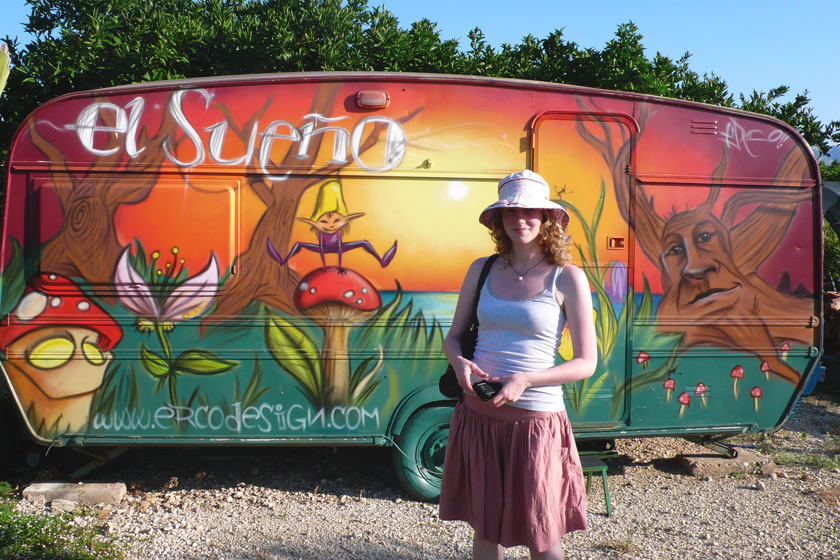 Me stood by a painted caravan