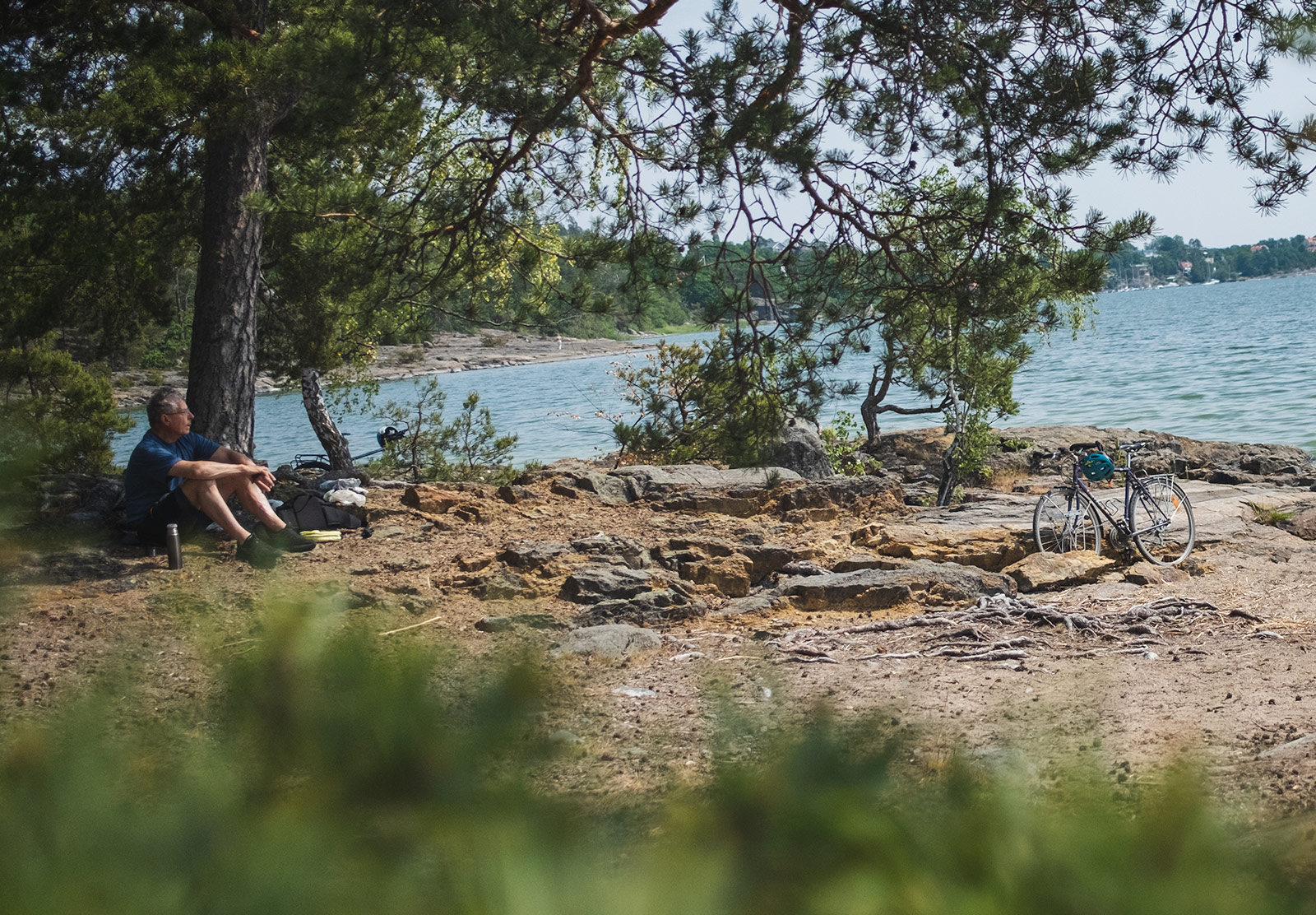 Man sitting on beach with bike