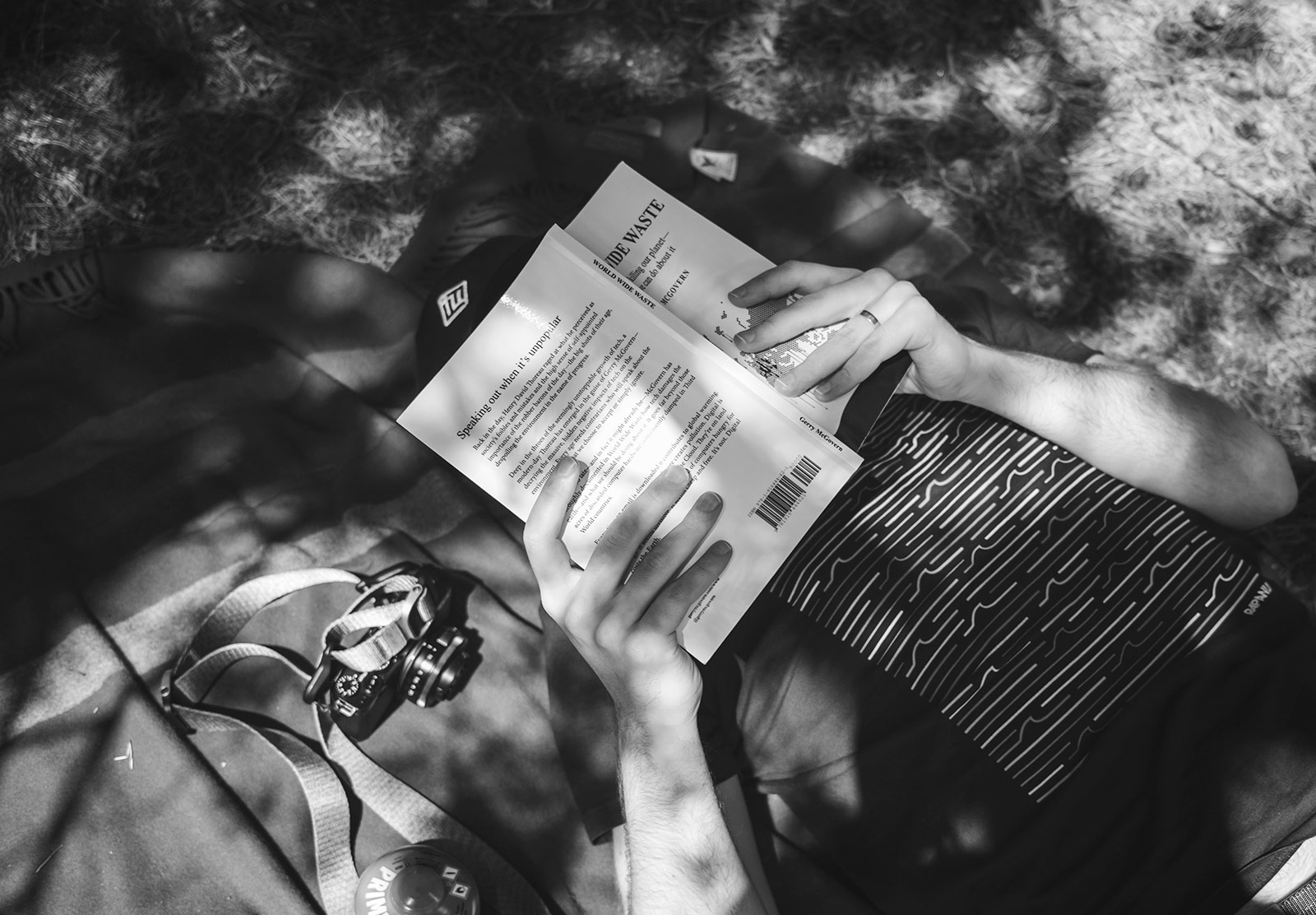 Man with book over face
