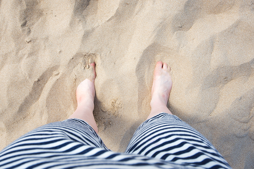 Feet covered in sand