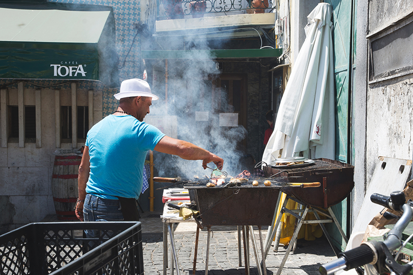 Man grilling fish outdoors