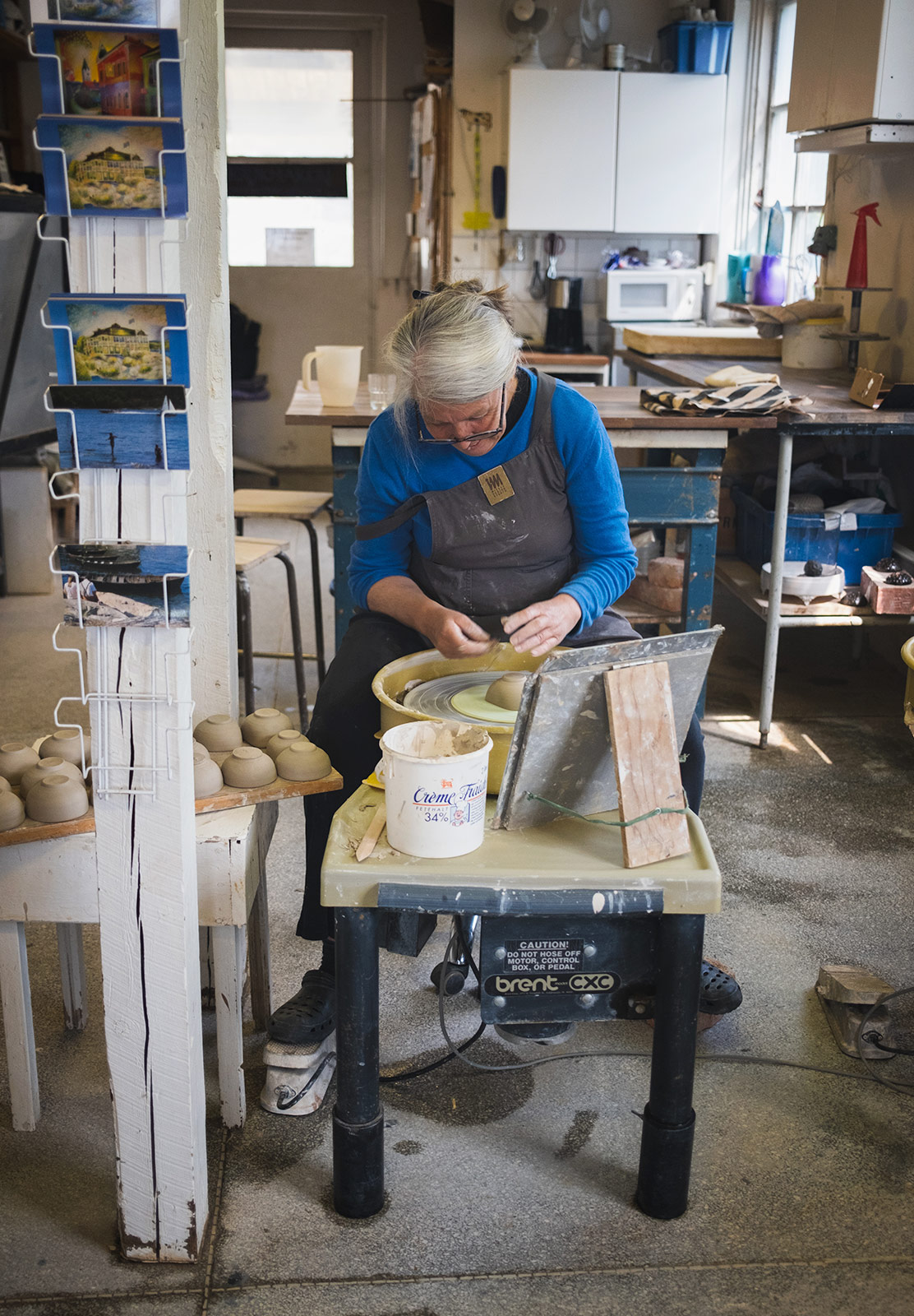 Lady spinning a clay cup