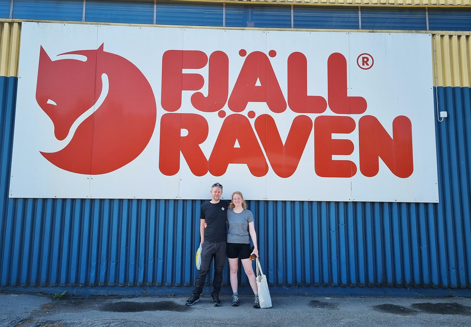 Couple stood under sign