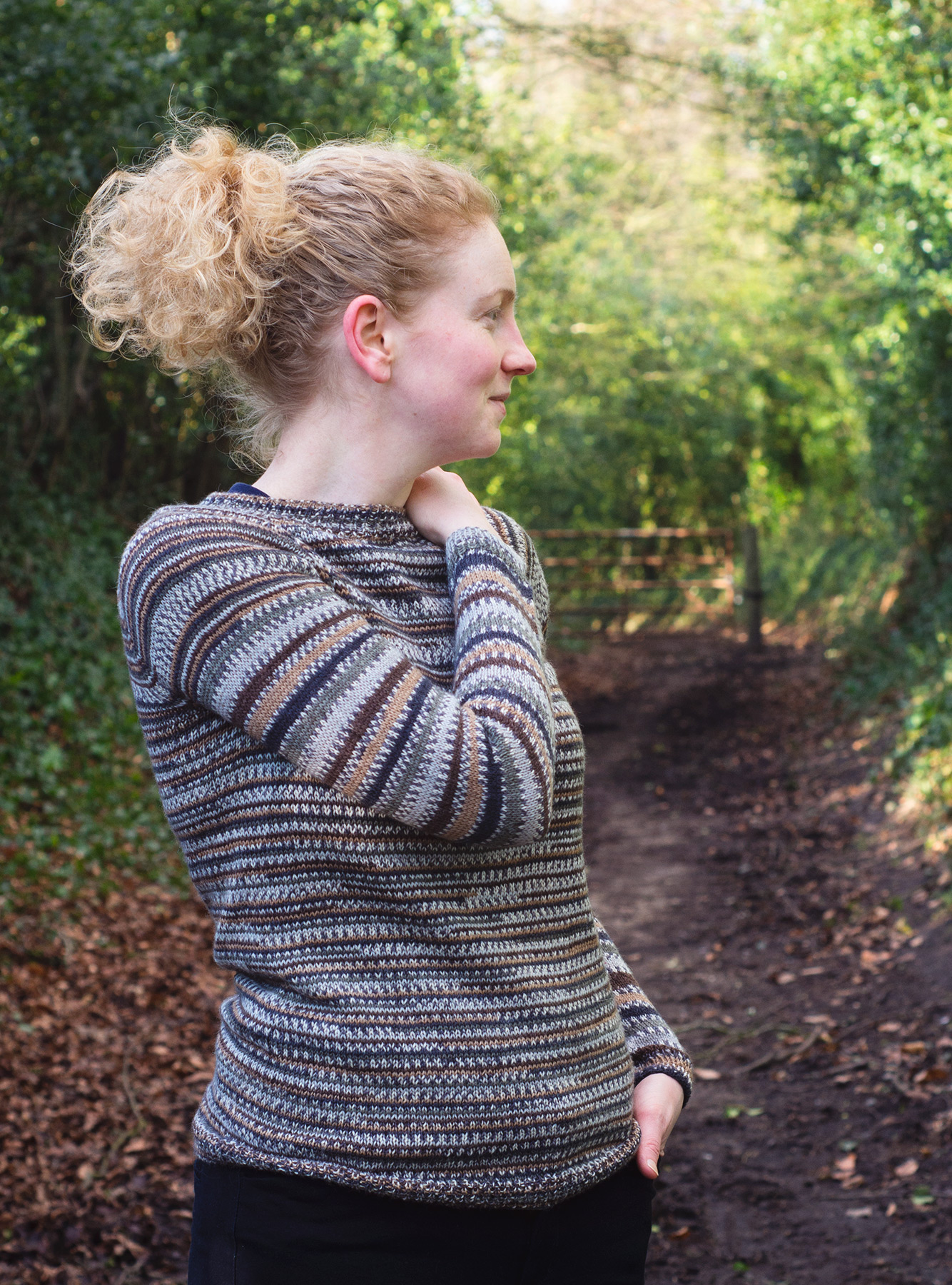 Woman in knitted jumper looking sideways
