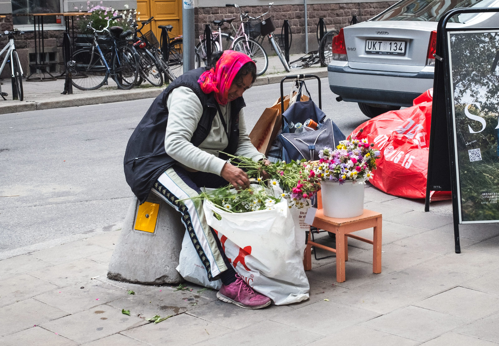 Lady selling bunches of flowers on street